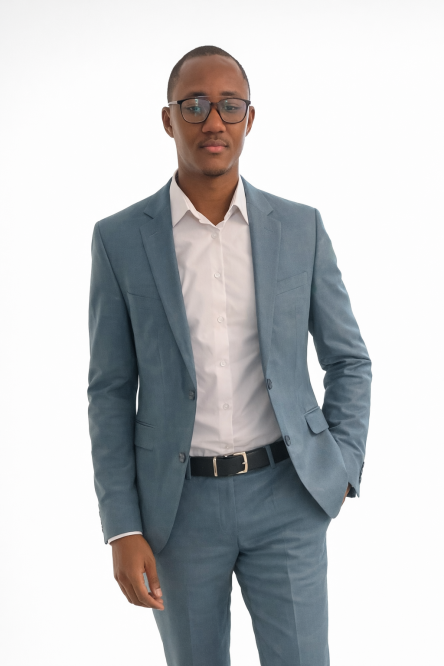 Professional studio portrait, bust (head and shoulders) of a West African man, smart casual (navy or charcoal blazer, plain light shirt, no tie), confident and approachable expression, even soft key light with gentle rim light, seamless navy background in hex #0B1F3B, high-resolution, realistic photo, editorial quality